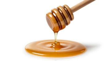 Honey dripping from a wooden dipper onto a white surface creating a small pool photo