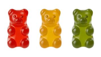 Close up of three gummy bears in red yellow and green on a white background photo