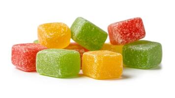 A close up shot of a pile of colorful square gummy candies on a white background surface photo