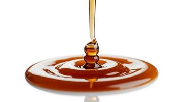 Close up of honey pouring creating a circular pattern on a white background photo