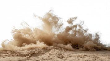 A cloud of dust rising from a sandy ground with small rocks against white backdrop photo