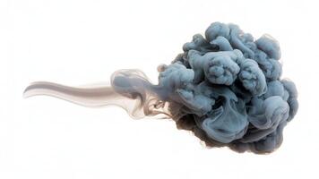 A cloud of gray smoke or pigment spreading out in water against a white background photo