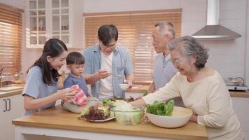 Family members gather in a bright kitchen to prepare a fresh salad. The adults chop vegetables while a child interacts with them, creating a warm atmosphere full of joy and togetherness. video