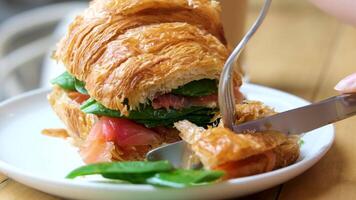 Croissant salmon spinach Breakfast, croissant sandwich toasted with toppings in it. Avocado, tomatoes, scrambled egg, prosciutto and slices of manchego cheese. video