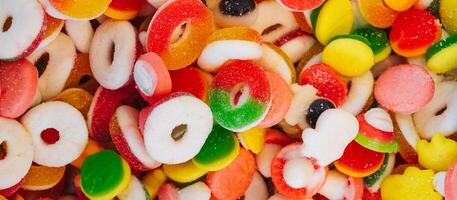 Assorted multi-colored marmalade candies. Jelly candy background. View from above. panoramic. photo