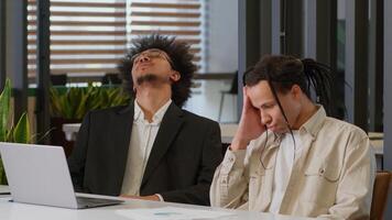 Two African American men business guys colleagues desperate stressed worried businessmen coworkers working together internet laptop at office online failure sad bad news computer problem notification photo