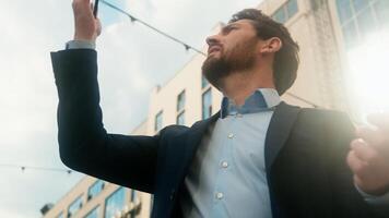 Middle-aged Caucasian business man confused with mobile phone lost signal Wi-Fi connection problem in city frustrated businessman male outside office holding smartphone searching connect online fail photo
