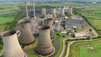 Aerial drone shot of West Burton power station with cooling towers and smoke stacks in rural England video
