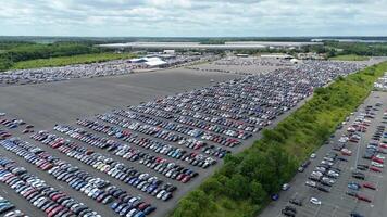 High altitude drone image of automotive dealership yard packed with cars in Corby video