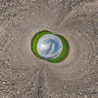 A view of a green field from inside a hole photo