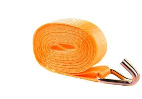 Orange lashing strap with metal ratchet and hook, displayed on clean white background. Used for securing cargo during transport. photo