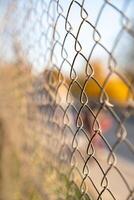 Selective focus of chain-link fencing, formed by the interlocking wires. photo