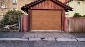 A captivating wooden garage stands proudly, surrounded by vibrant modern buildings and lush greenery photo