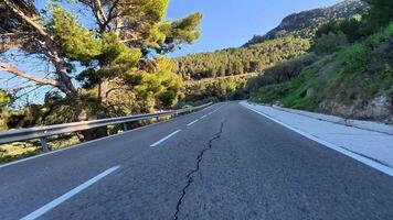 A stunningly picturesque mountain road, gracefully winding through lush greenery and incredible natural beauty photo
