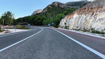 Beautiful winding road with lush greenery and peaceful landscape, perfect for travel and exploration. photo
