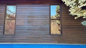 Explore the sleek design of this remarkable wooden house with clear reflections and beautiful surroundings photo