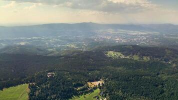 A stunning aerial view showcasing the expansive green mountains alongside the beautiful and serene valleys below photo