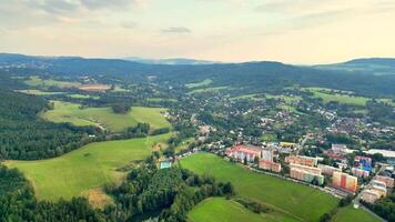A stunning aerial view that beautifully captures the lush greenery and charming town nestled among rolling hills photo