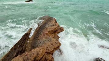Waves crash against rocky outcrops, creating a tranquil coastal scene. Perfect for nature enthusiasts. photo
