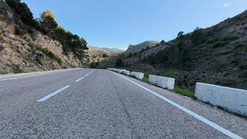 Capture the breathtaking beauty of a winding mountain road, completely surrounded by stunning nature scenery photo