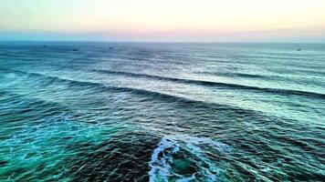 A breathtaking view of the ocean waves in calming colors during sunset, perfect for relaxation visuals. photo