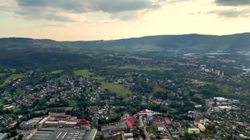 This stunning aerial photograph captures a serene valley embraced by lush hills and urban developments photo