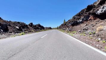 A beautiful and picturesque highway that is surrounded by stunning lava rock landscapes and clear blue skies photo