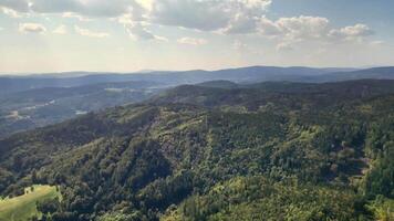 A stunning aerial perspective of verdant mountains and rolling hills, capturing nature's tranquility. photo