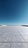 Expansive tiled rooftop terrace under a clear blue sky offering minimalist architecture and serene ocean views photo