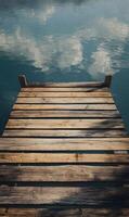 A serene wooden dock stretching into calm waters reflecting the sky above peaceful atmosphere creating tranquility and calm photo