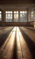 Sunlight streams through windows casting shadows across a vintage wooden floor in an empty room revealing warmth and architectural charm photo