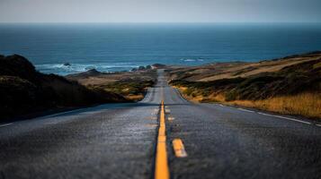 Scenic coastal highway offering a path to the horizon with the vast ocean in the background photo