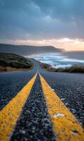 A coastal highway stretches towards the horizon with the ocean and sky meeting in a scenic view promising freedom adventure and serene travel photo