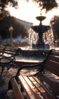 Urban tranquility a sunlit park scene showcasing a classic fountain surrounded by inviting benches and architecture in the background photo