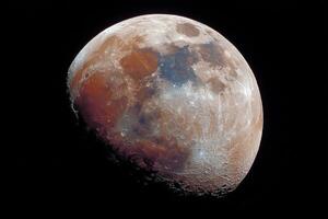 Detailed lunar surface reveals craters and textures as seen from a suburban area under the night sky photo