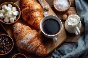 Delicious croissants are accompanied by a steaming cup of black coffee and sugar cubes on a rustic wooden table during breakfast photo