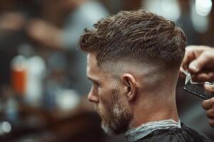 A barber is skillfully cutting a man's hair with clippers in a classic barbershop setting filled with warm lighting photo