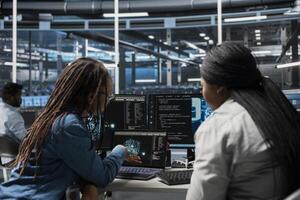 Data center admins using AI visualization tools to setup machine learning systems handling information. Experts using data analytics graphs to train neural networks to improve server farm operations photo