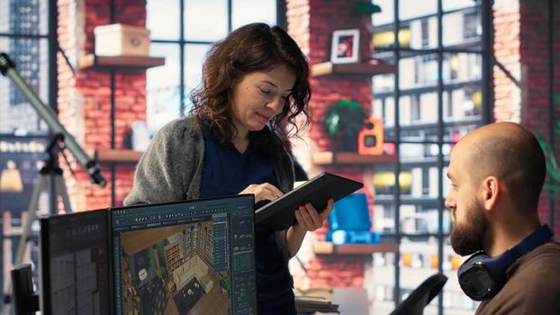 Workers in office use CAD software to design a house interior, providing a user interface for virtual home planning. Team of developers creating architectural layout and adjustments. Camera B. photo