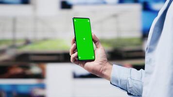 Male web user navigates phone with copy space for social media platforms, showcasing creativity and mobile technology to ensure online connection for entertaining activity. Camera A. photo