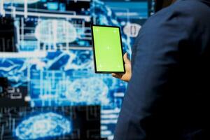 African american person holds tablet with mockup display with cloud computing, focused on AI brain development and deep learning for innovation. Smart technology data science concept. photo