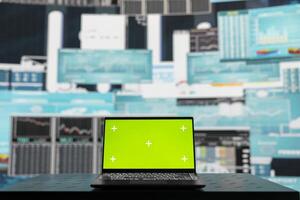 Empty business space has a laptop screen with chroma key, showcasing infographics and reports for effective decision making and strategy planning. Artificial intelligence brain data visualization. photo