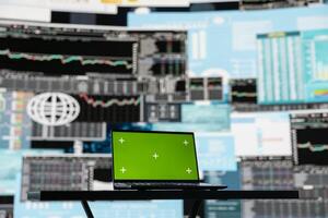 Laptop screen with a chroma key in empty space next to performance metrics, showcasing finance graphs and strategy tools to guide a new investment and decision making. Business growth. photo