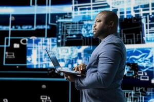 African american IT engineer works in AI ethics and neural networks, virtual intelligence brain tools for machine learning systems. Algorithmic thinking development on dashboard. photo
