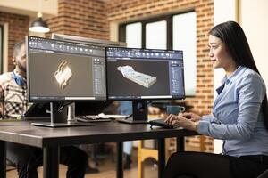 Professional female engineer manufacturing machinery models with advanced CAD software. Asian woman technician sitting at desk and designing mechanical products on a digital interface. photo