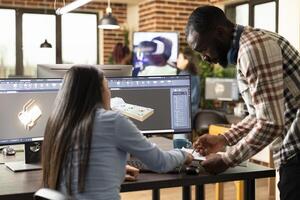 Professional male and female engineers designing an industrial engine prototype with CAD tools. Diverse creative experts exchanging ideas and sketching mechanical components on a multi monitor. photo