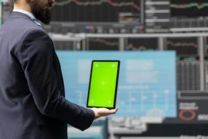 Entrepreneur holds tablet with copy space screen and leveraging dashboards, finance trends and KPI metrics to optimize corporate performance and plan for future success. Growth planning. photo