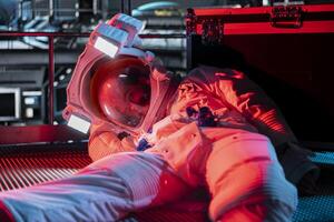 Red light alert blinking over unconscious astronaut losing life in accident onboard space station after sudden system failure. Cosmonaut suffering asphyxiation, having medical emergency photo
