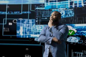 African American businessman studying digital AI brain interface, symbolizing neural networks, data science and algorithmic thinking. Cybernetics for a high tech futuristic innovation. photo
