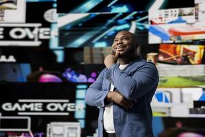 African american young guy connected to a global network through mobile devices, opening apps and streaming services platforms. Emphasizing communication and user interface evolution. photo